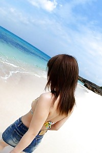 Heartwarming Asian Chick In A Bikini Is Liking The Delightful Sun And Sand While Teasing